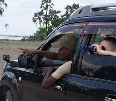 A guide with a group of tourist driving through Liwonde